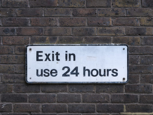 Weathered Exit on Textured Brick Wall Mural