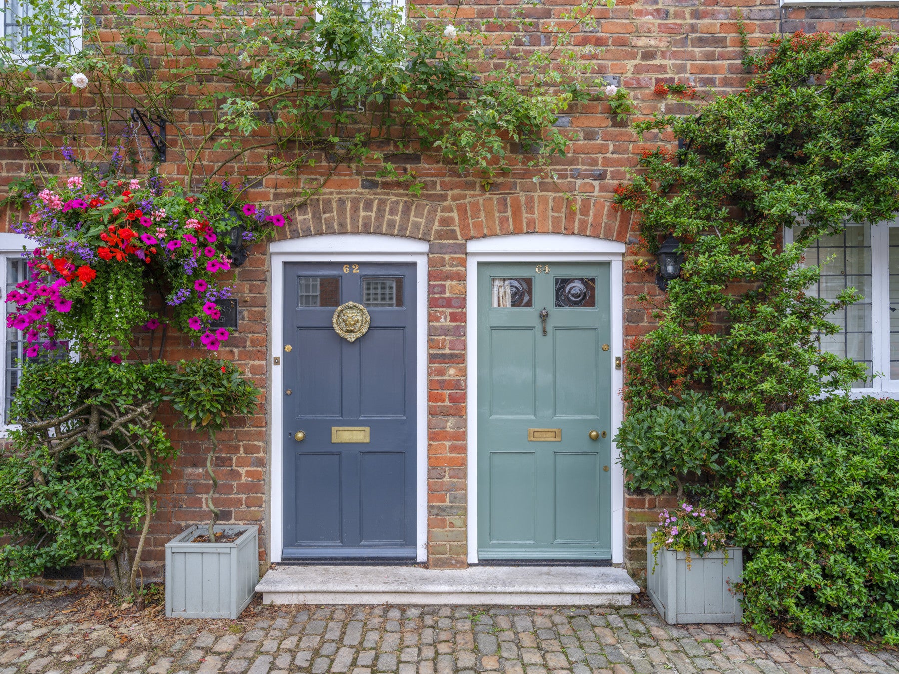 Cottage style wall mural with flowers around brick doorways
