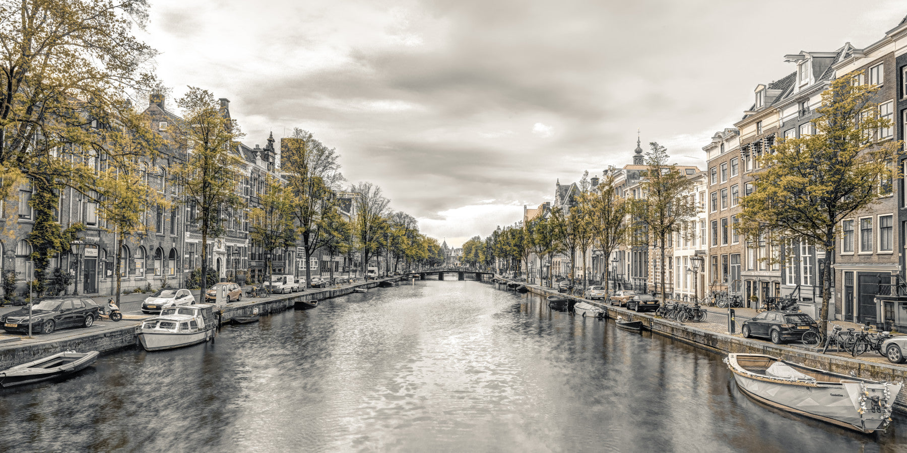 City wallpaper of a Dutch canal behind a cream sofa in a living room GD13043