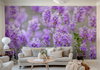 Lavender Farm wallpaper mural of close-up purple lavender blooms behind a beige sofa and cushions in a bright living room