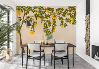 Bright yellow lemons hanging from branches on a neutral wall mural.
