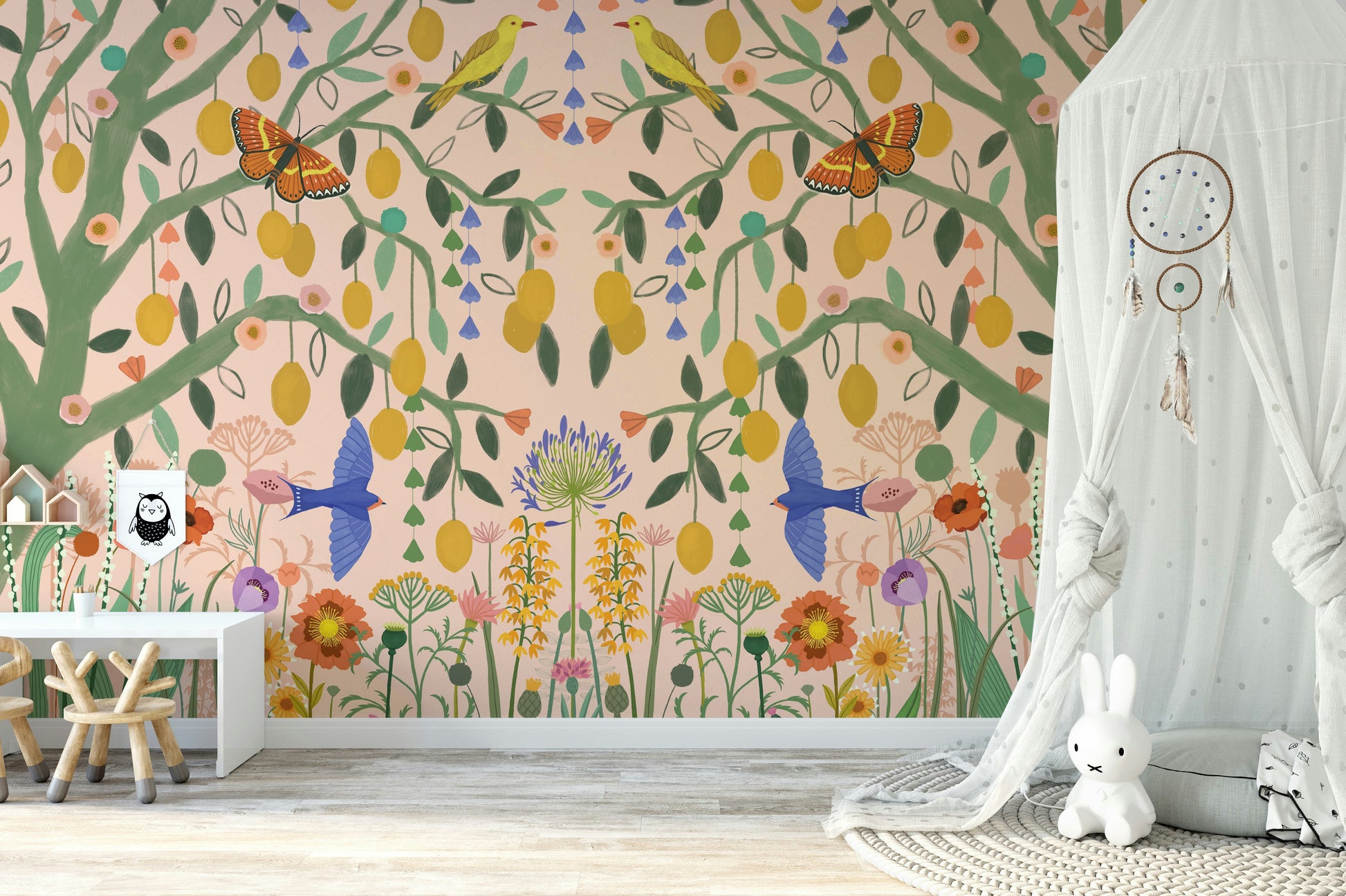 Fresh citrus tree wallcovering for a nursery with organic cotton textiles and timber toys.