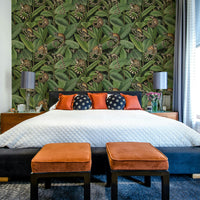 A wallpaper with a repeating pattern of ficus trees and monkeys.
