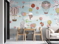 Levitating animals wallpaper mural styled as a living room feature wall behind a sofa and seating in soft pastel tones
