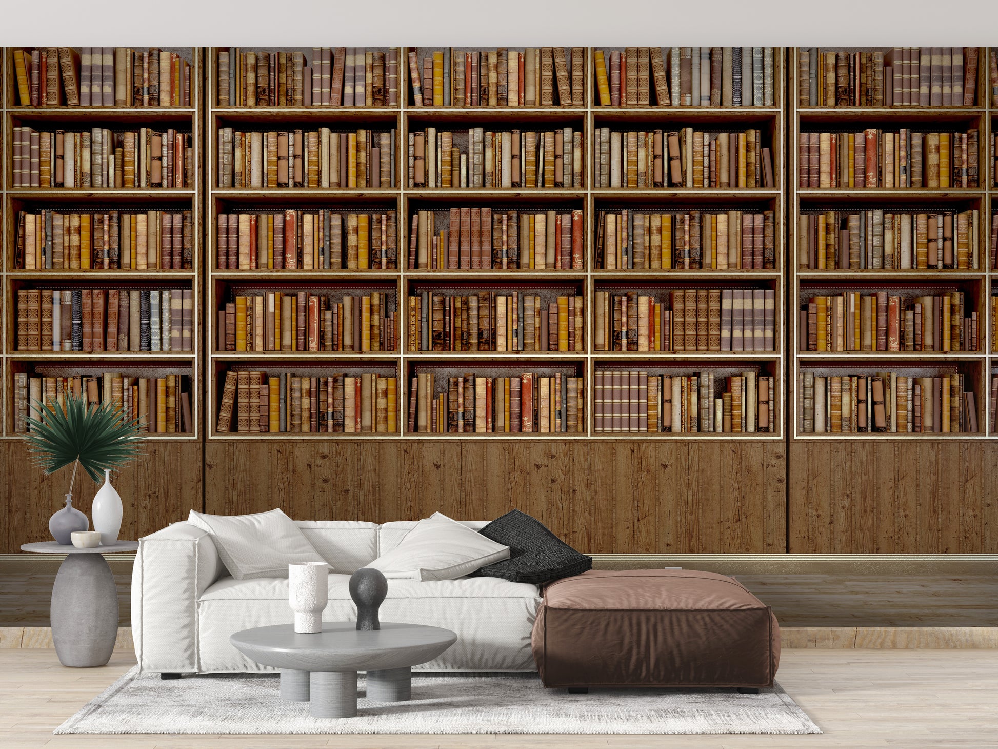 Library Bookcase wallpaper mural of stacked books behind a white sofa and brown leather ottoman