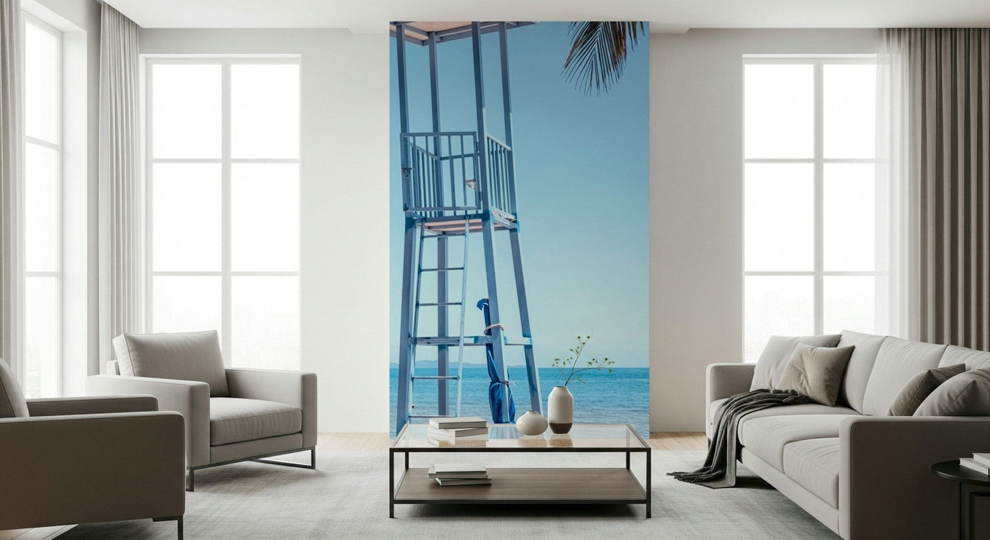 Ocean lookout mural behind grey couch, airy coastal living space feature wall