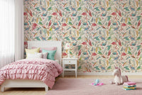 light Birdwatcher's wallpaper of flamingos and songbirds behind a pink ruffled girls bed with a unicorn plush
