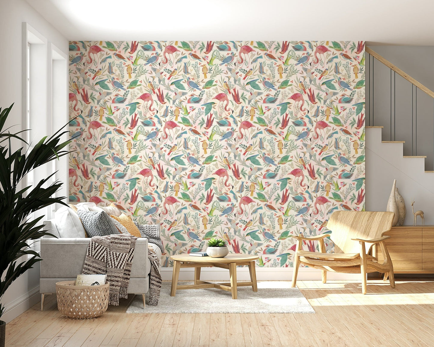 light Birdwatcher's wallpaper of watercolor birds above a grey sofa and wood armchair beside a staircase