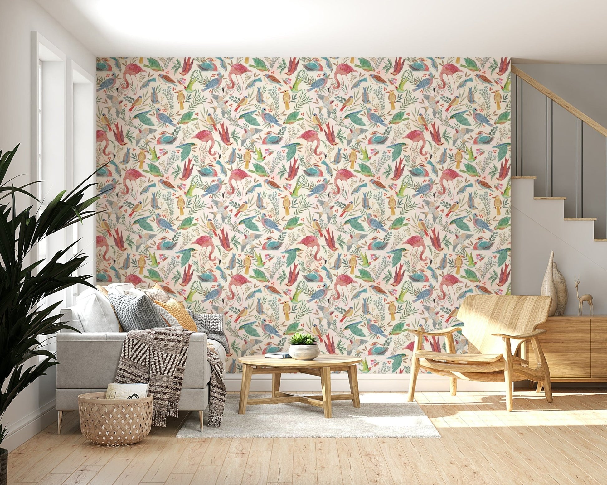 light Birdwatcher's wallpaper of watercolor birds above a grey sofa and wood armchair beside a staircase