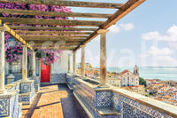 Lisbon vista bloom wall mural with tiled terrace, red door, and sea horizon view