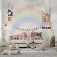 Little Girls Adventures wall mural of a rainbow and swinging girl above a cream daybed with pink pillows
