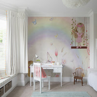 Little Girls Adventures wall mural with a pastel rainbow behind a white desk and chair in a bright girls room