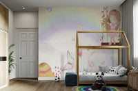 Little Girls Adventures wall mural of a rainbow and fairies above a wood house-frame bed with a panda plush