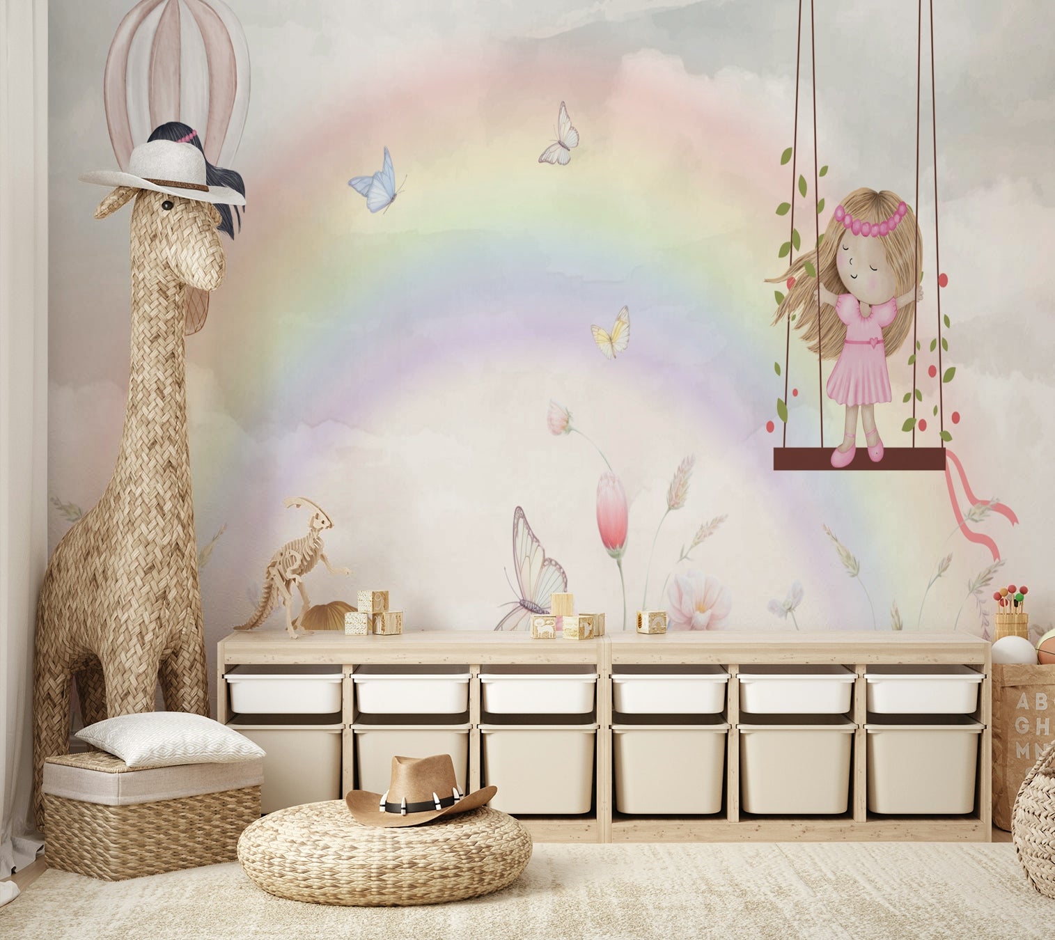 Little Girls Adventures wall mural of a rainbow and fairies beside a woven giraffe figure and toy storage bins