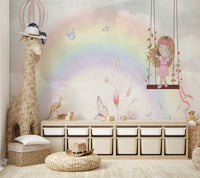 Little Girls Adventures wall mural of a rainbow and fairies beside a woven giraffe figure and toy storage bins