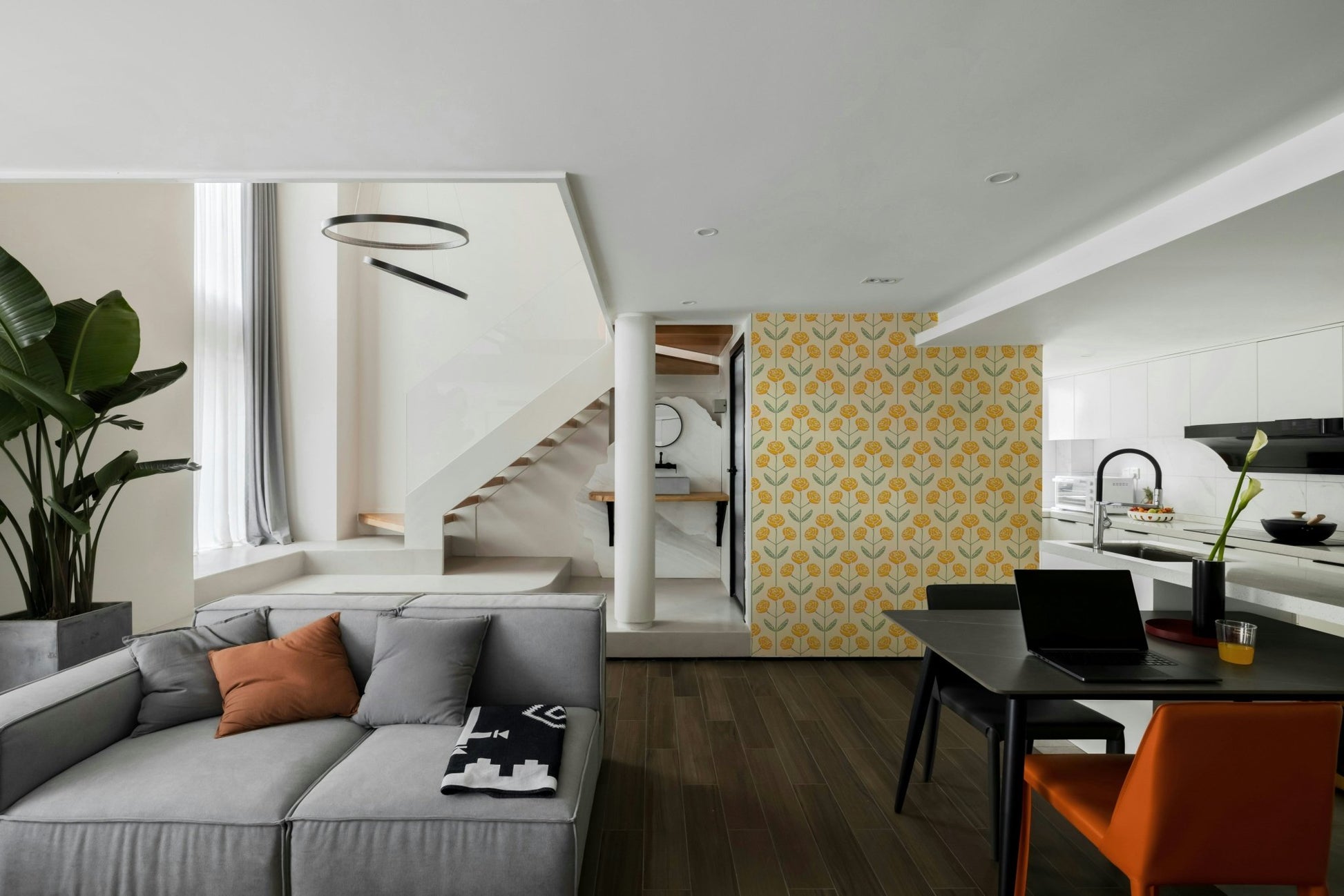 Stylized floral and leaf patterns in yellow and sage green on a wall.

