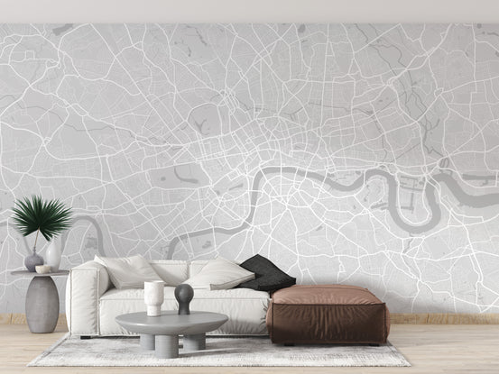 London City wallpaper mural showing a grey street map and the Thames behind a white sofa and brown leather ottoman