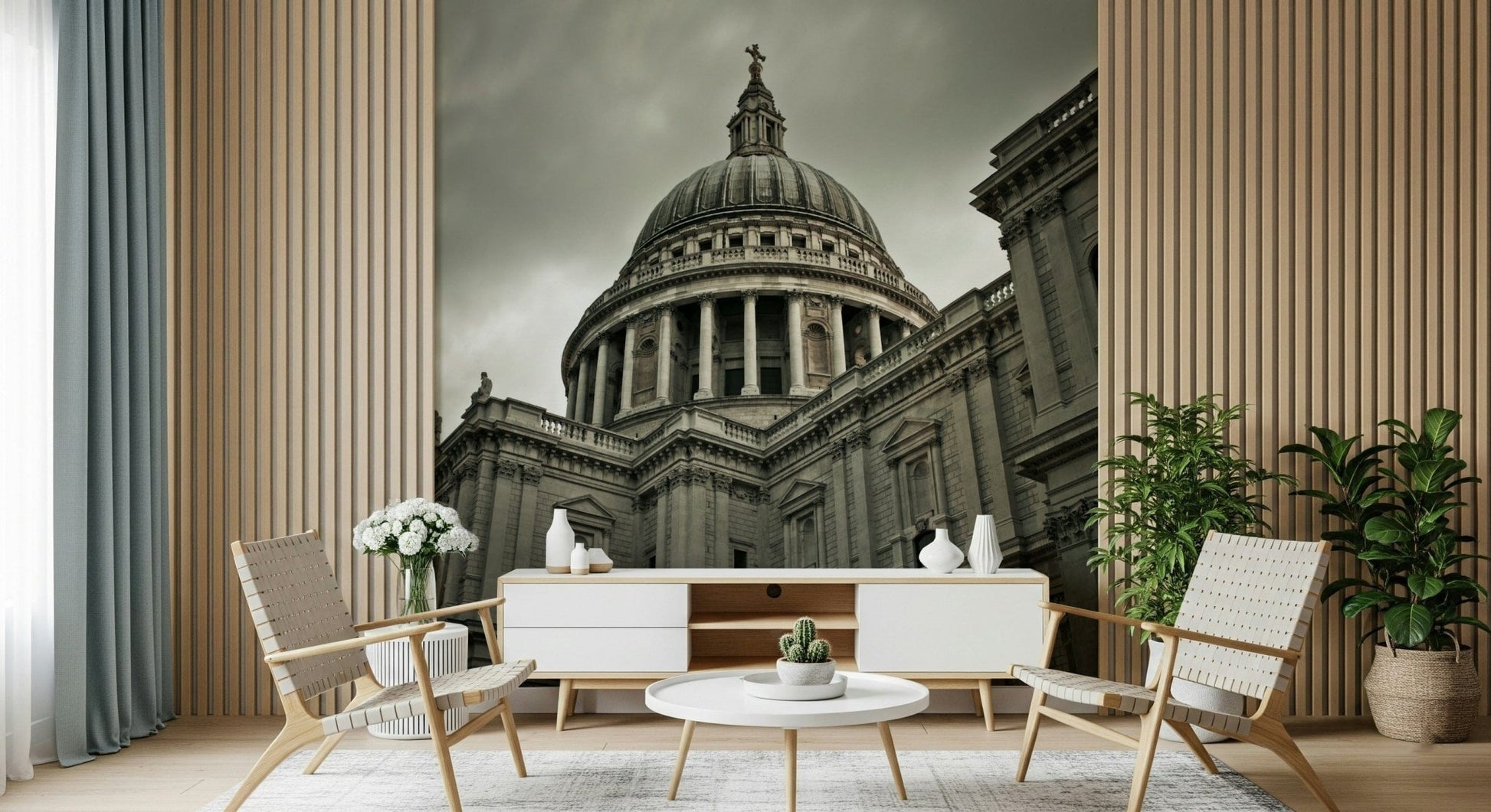 London Grandeur wallpaper mural of St Paul's under a grey sky behind a white console and woven chairs in a living room