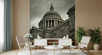 London Grandeur wallpaper mural of St Paul's under a grey sky behind a white console and woven chairs in a living room