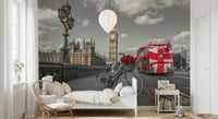 London Ride wallpaper mural in a kids bedroom with a white bed, rattan chair and balloon light