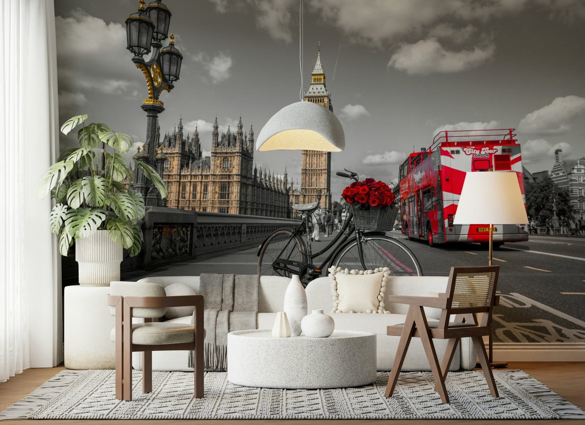 London Ride wallpaper mural in a living room with a white sofa, cane chair and big monstera plant