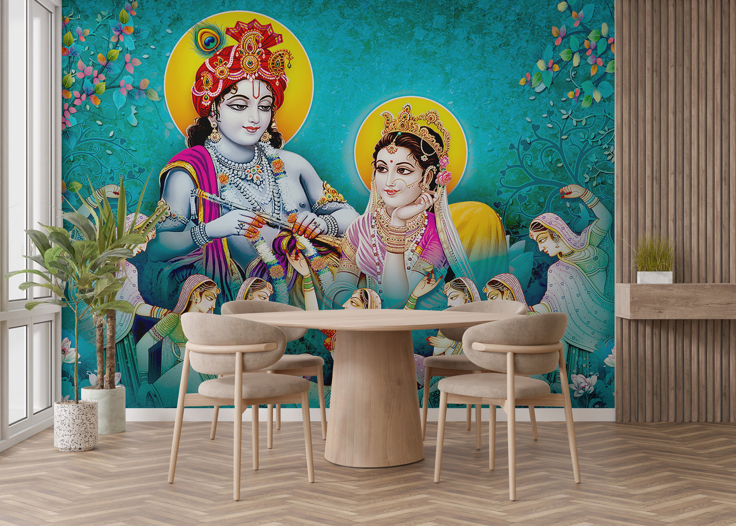 Lord Radhe Krishna and Gopis wallpaper mural in vivid turquoise behind a round wood dining table and beige chairs