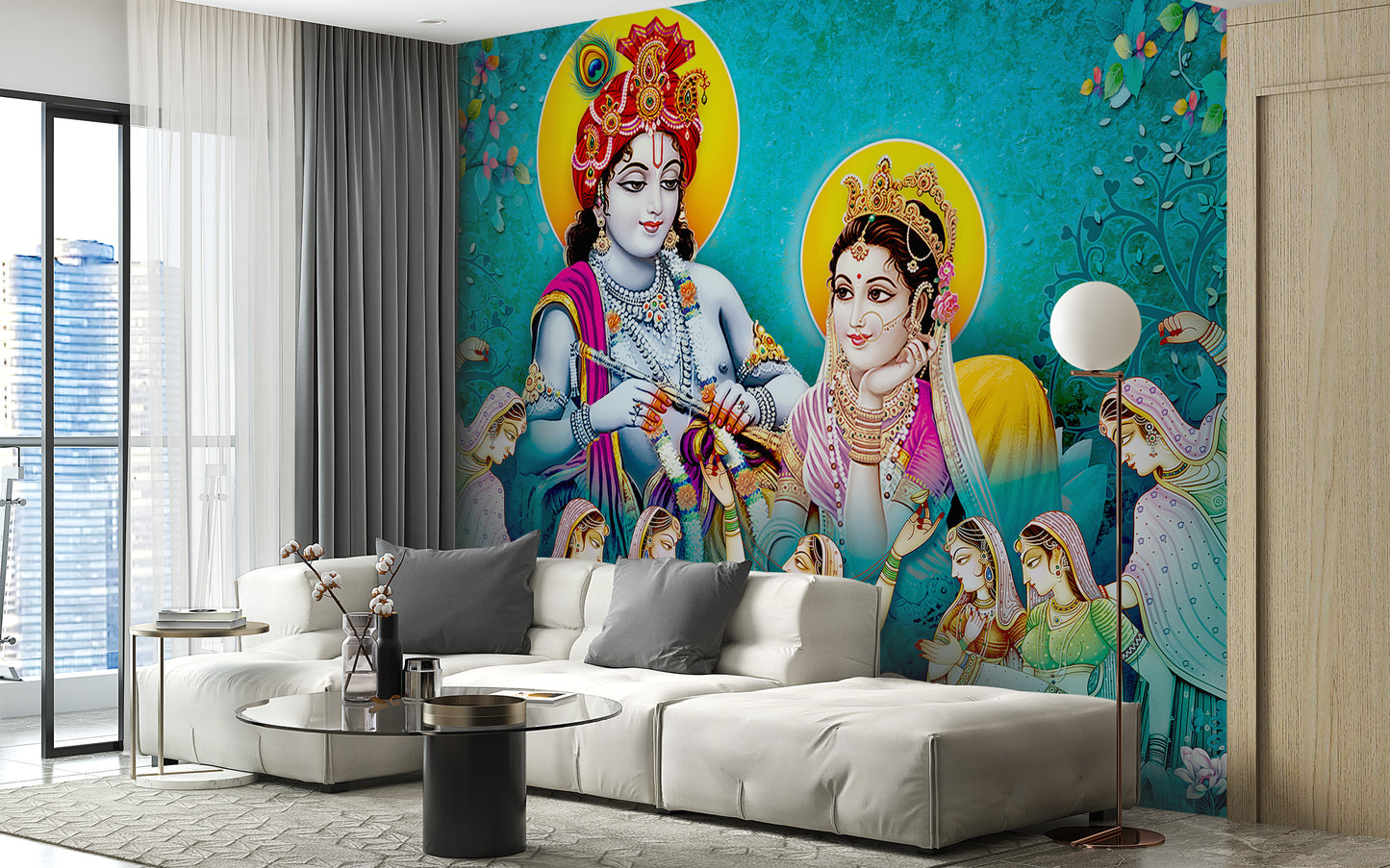 Lord Radhe Krishna and Gopis wallpaper mural in turquoise behind a white sofa and glass table in a living room