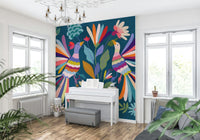 Love Birds mural of two colorful birds on blue behind a white piano in a bright music room