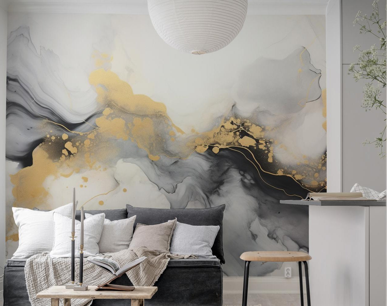 Luxurious Black and Gold Abstract Marble wallpaper mural in grey and gold behind a dark sofa and wood bench in a living room