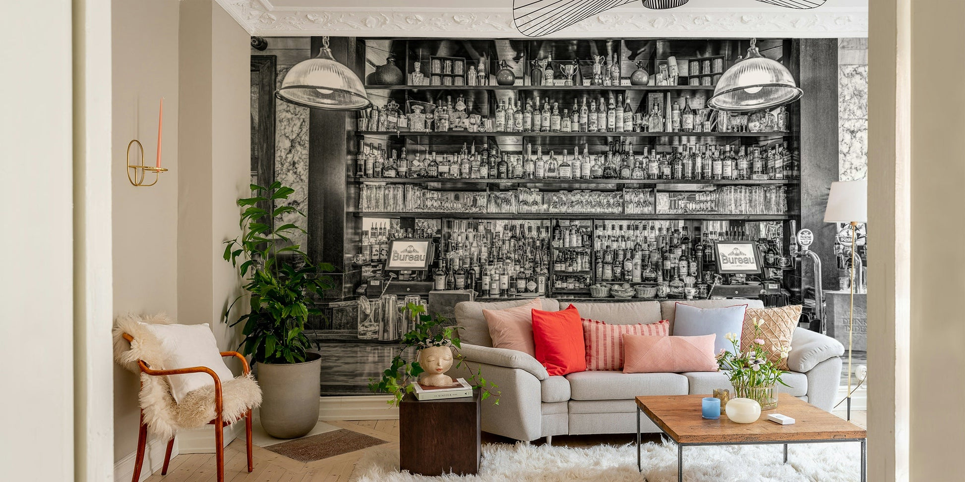 The shelves are filled with glasses and many different bottles.

