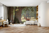 A bedroom with the forest mural behind the headboard.

