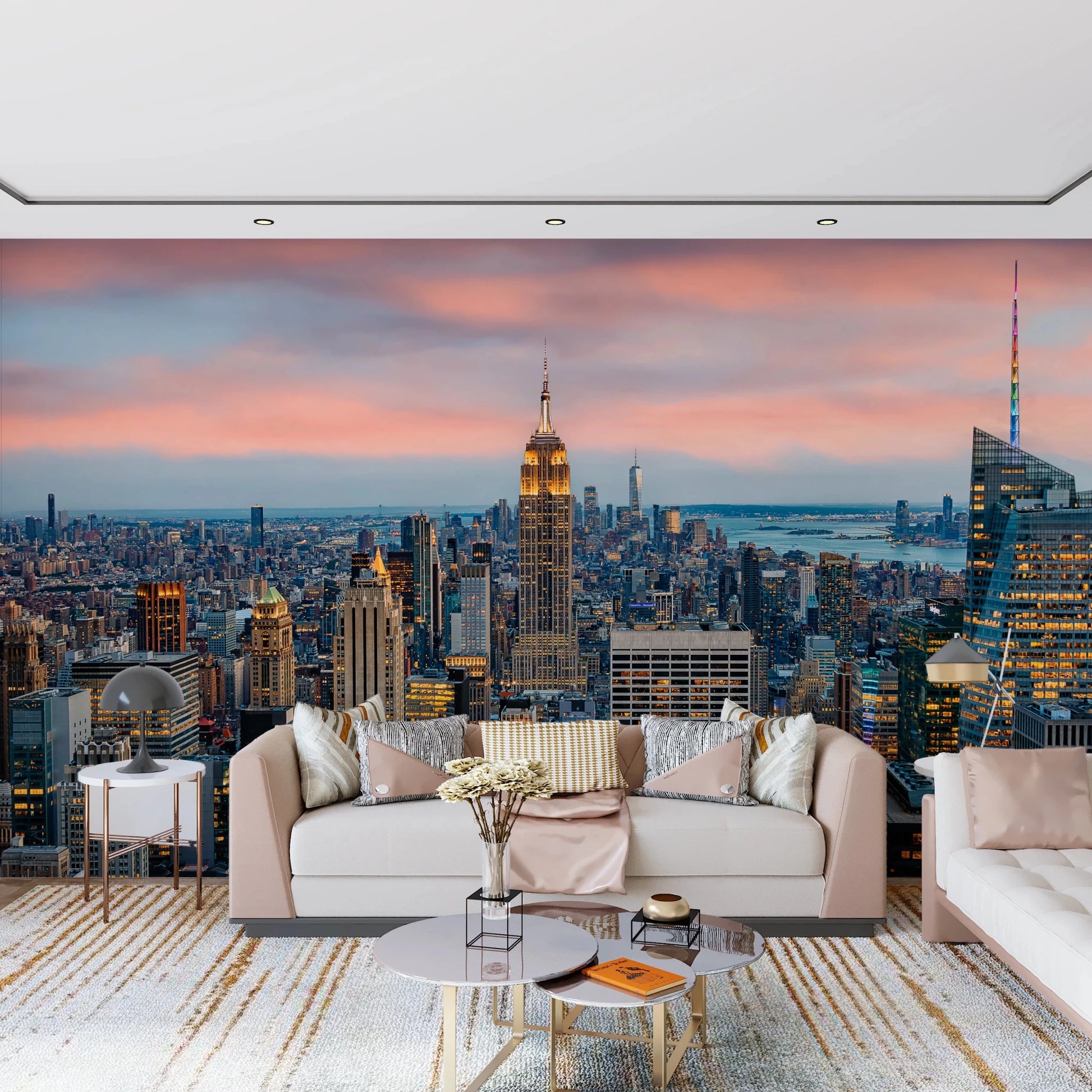 Manhattan Dawn wallpaper mural of the skyline at dusk behind a cream sofa with satin pillows