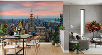 Manhattan Dawn wallpaper mural with the Empire State Building behind a black dining table and wood chairs