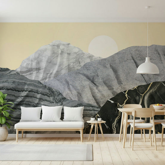Stony Peaks Marble Sun wallpaper mural of grey marble mountains and a pale sun behind a white bench in a living-dining room