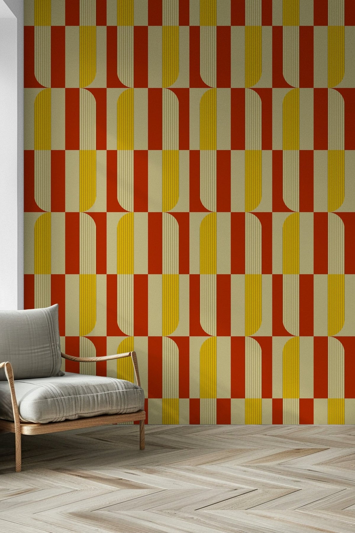 Marigold and Maple wallpaper with retro yellow and orange arches behind a grey wood-frame armchair