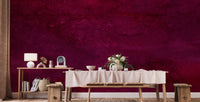 Maroon Watercolor wallpaper mural in dark magenta behind a wood dining bench and table with floral centerpiece
