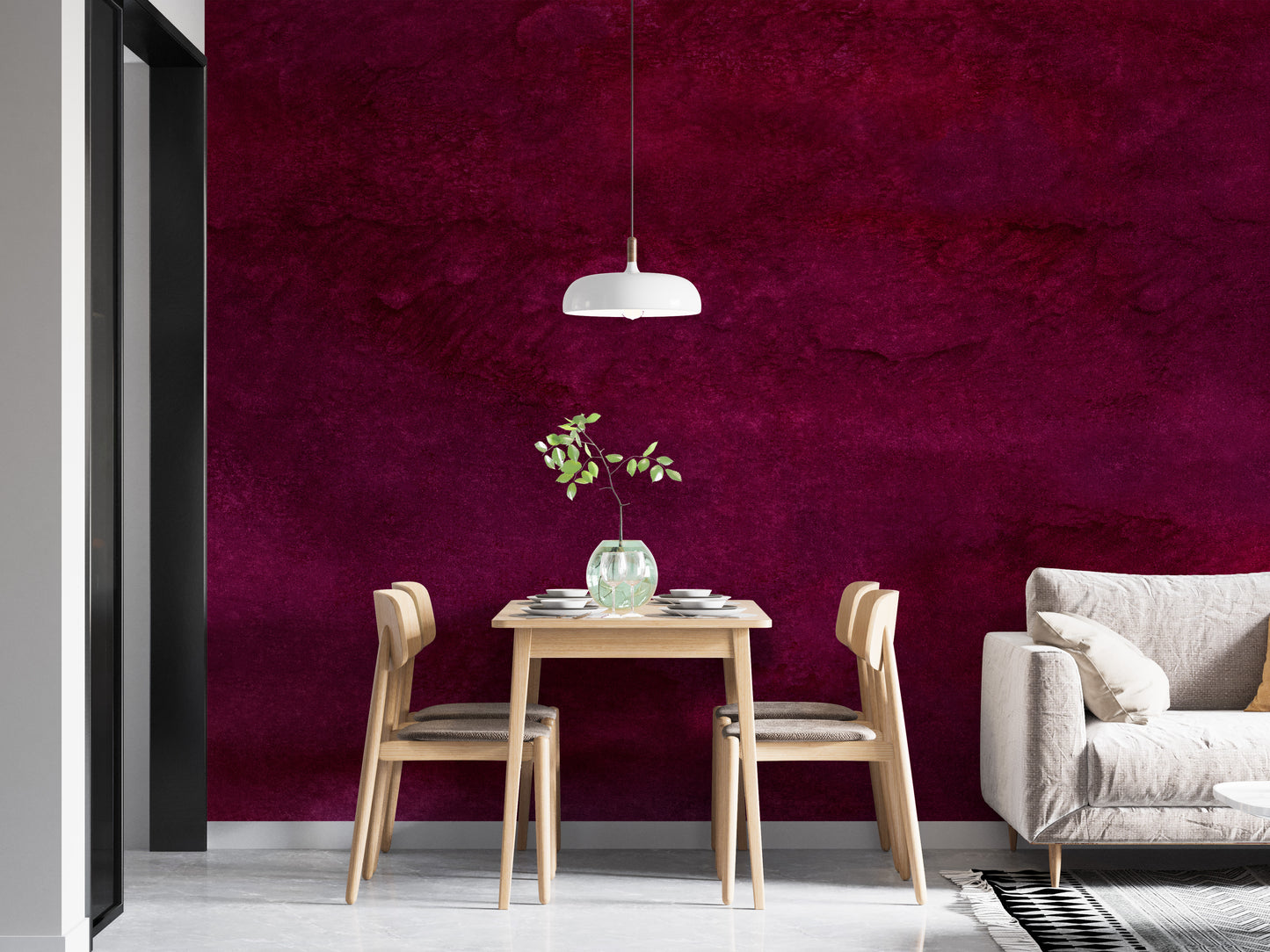 Maroon Watercolor wallpaper mural in deep magenta wash behind a light wood dining table and white sofa in a dining area