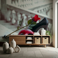 Masquerade Romance wallpaper mural with red rose and black heel behind a wooden console with woven baskets and ceramic vases