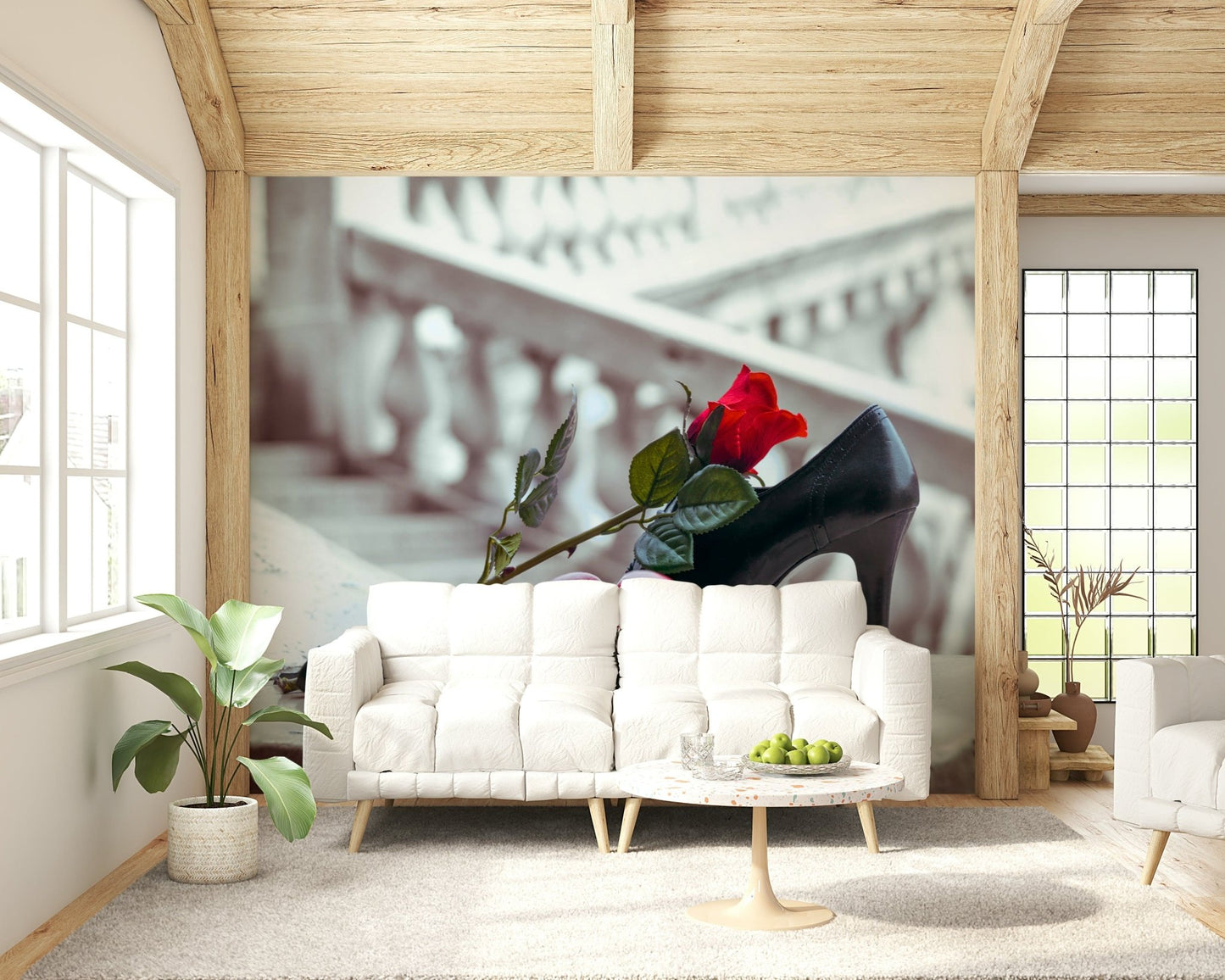 Masquerade Romance wallpaper mural of red rose and black heel behind a white sofa and marble table under wood beams