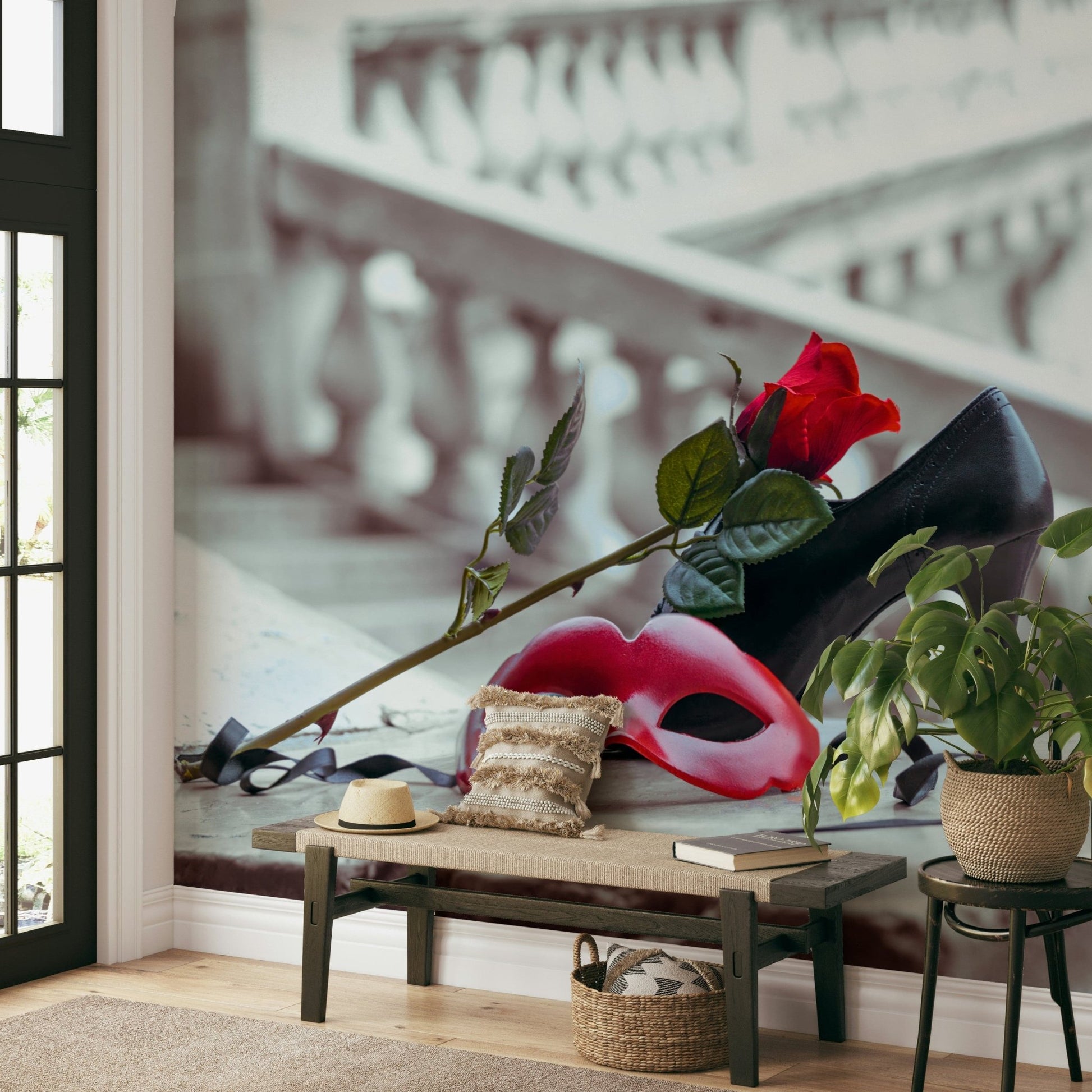 Masquerade Romance wallpaper mural with red mask and rose behind a wooden entryway bench, sun hat and potted plant