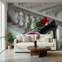 Masquerade Romance wallpaper mural of red rose and black heel behind a cream sofa and round wood coffee table in a living room