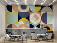 Mescolanza Alt V3 wallpaper mural of bold geometric shapes in a cafe dining area with white tables and navy chairs