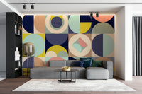 Mescolanza Alt V3 wallpaper mural of mid-century circles behind a grey sectional sofa and black shelving in a living room