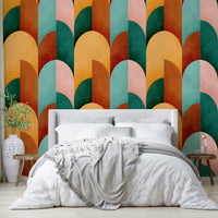 Mid Mod Geometry Sunburn wallpaper mural behind a white upholstered headboard with white bedding and grey throw
