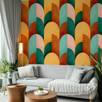 Mid Mod Geometry Sunburn wallpaper mural in orange and teal arches behind a light grey sofa with wooden side tables