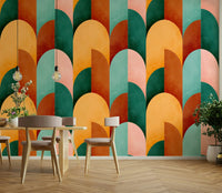 Mid Mod Geometry Sunburn wallpaper mural with bold arches behind a mustard sectional sofa with yellow pillows