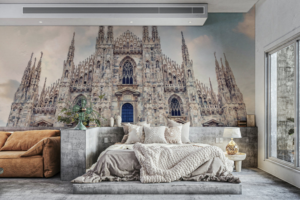 Milan Cathedral Majesty wallpaper mural behind a platform bed with gray bedding and a rust sofa in a bedroom