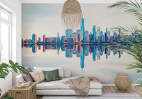 Mirrored Metropolis wallpaper mural of the reflected skyline behind a white chaise daybed with a rattan pendant