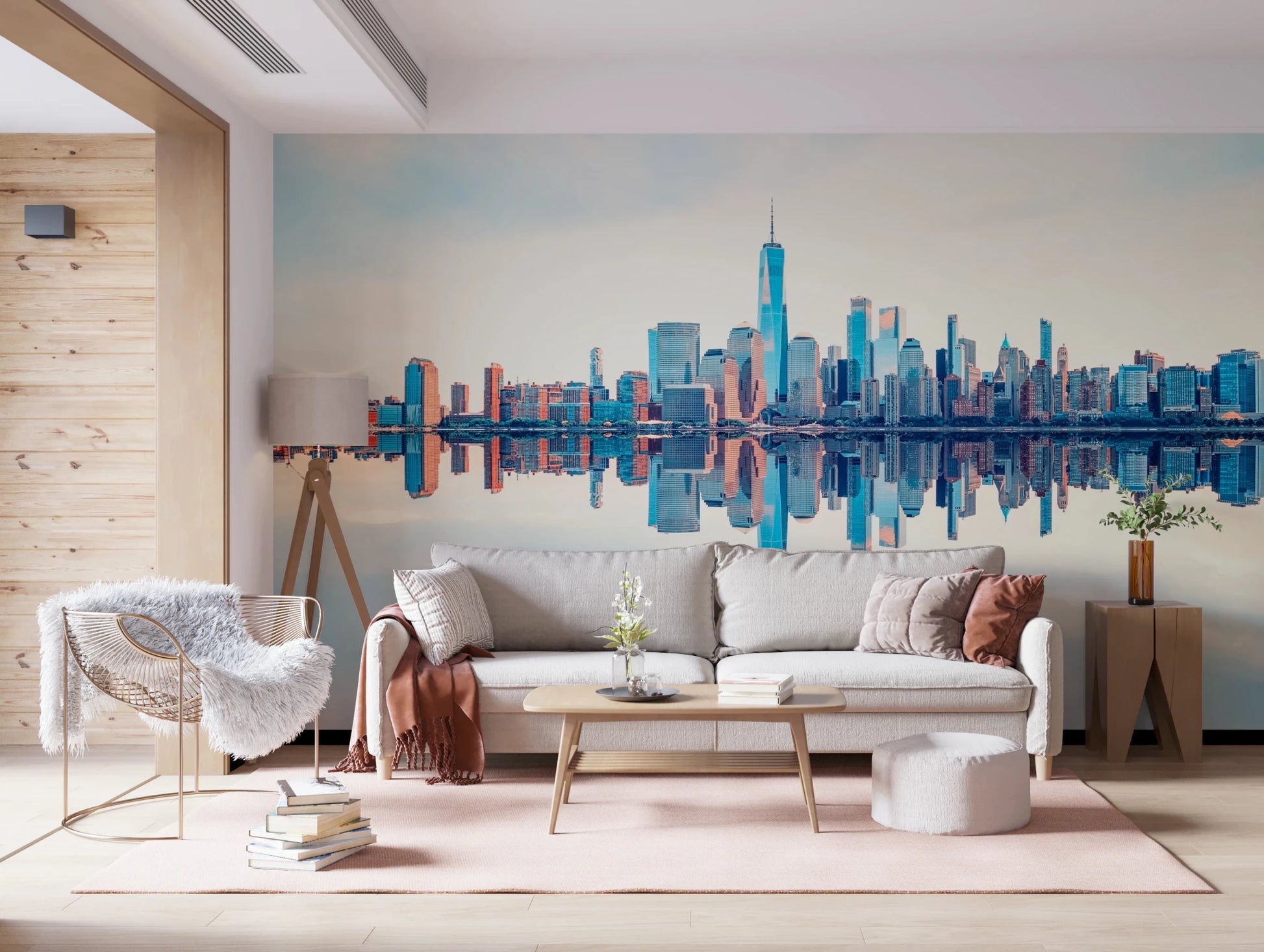Mirrored Metropolis wallpaper mural of the mirrored city behind a cream sofa with a fluffy chair on a pink rug