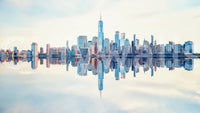 Mirrored Metropolis wallpaper mural shown as a full-wall view of the Manhattan skyline mirrored on calm water